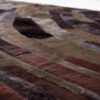 Close-up of Drift 00965 luxury designer rug with textured, abstract hide pattern.
