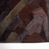 Close-up of Drift 00965, a luxury designer handmade hide rug in brown, maroon, and olive.
