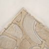 Close-up of Bloom 01482 luxury designer rug with beige and brown handmade hide patchwork.