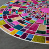 A luxury custom designer rug with vibrant mosaic rectangles on a smooth floor.