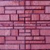 Close-up of luxury designer rug with pink geometric tiles and high-end texture.