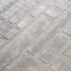 Luxury designer rug in beige with geometric high-low pattern and modern style.
