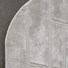 A luxury designer rug with a light gray geometric pattern on a dark floor in Tower House.