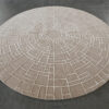 The Tower House 02881 luxury custom rug, a round high-end wool rug with a beige geometric pattern, elevates the modern concrete floor.