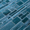 Close-up of luxury designer rug with teal, textured fur-like geometric shapes.