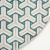 Luxury designer rug featuring a cream and teal geometric pattern on white.