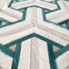 Close-up of a high-end designer rug, Mirage 19449, with teal geometric pattern.
