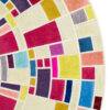 Close-up of luxury designer round rug with multicolored geometric wool segments.