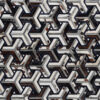 Luxury designer rug with interlocking 3D geometric pattern in neutral tones.