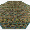 Luxury designer rug with octagonal shape, geometric Y-pattern in green, gold, brown.