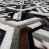Close-up of Mirage 13545, a high end designer rug handmade from luxury cowhide.