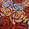 Close-up of a luxury designer rug with abstract rose motifs in silk and wool.