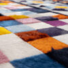 Close-up of Lady 24390, a luxury handmade designer rug with vibrant patchwork.