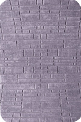 Luxury designer rug in gray with geometric raised lines and rounded corners.