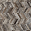 Detail of Mr Crowley 00646 luxury designer rug in herringbone hide pattern.