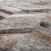 Close-up of Mr Crowley 00646 luxury designer rug with geometric chevron in handmade hide.