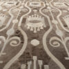 Close-up of a luxury custom designer rug with geometric beige and cream patterns.