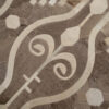 Close-up of a luxury custom designer rug with brown and beige geometric patterns.