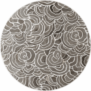 Luxury designer round rug with abstract floral pattern in gray on concrete floor.