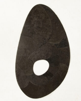 Luxury custom designer rug in abstract black oval with central hole on white.