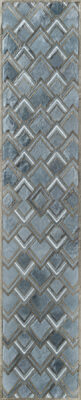 Luxury designer rug with overlapping silver and blue chevrons on textured wool.