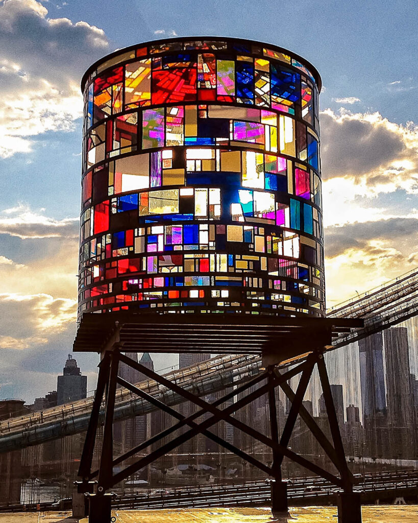 A stained glass water tower inspires luxury designer rugs with bold, vibrant colors.