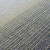 Detail of Custom 02664 luxury designer rug fabric with intersecting beige, yellow, and blue lines.