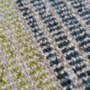 Close-up of luxury designer rug Custom 02664, featuring a textured wool checkered pattern in beige, green, and blue.