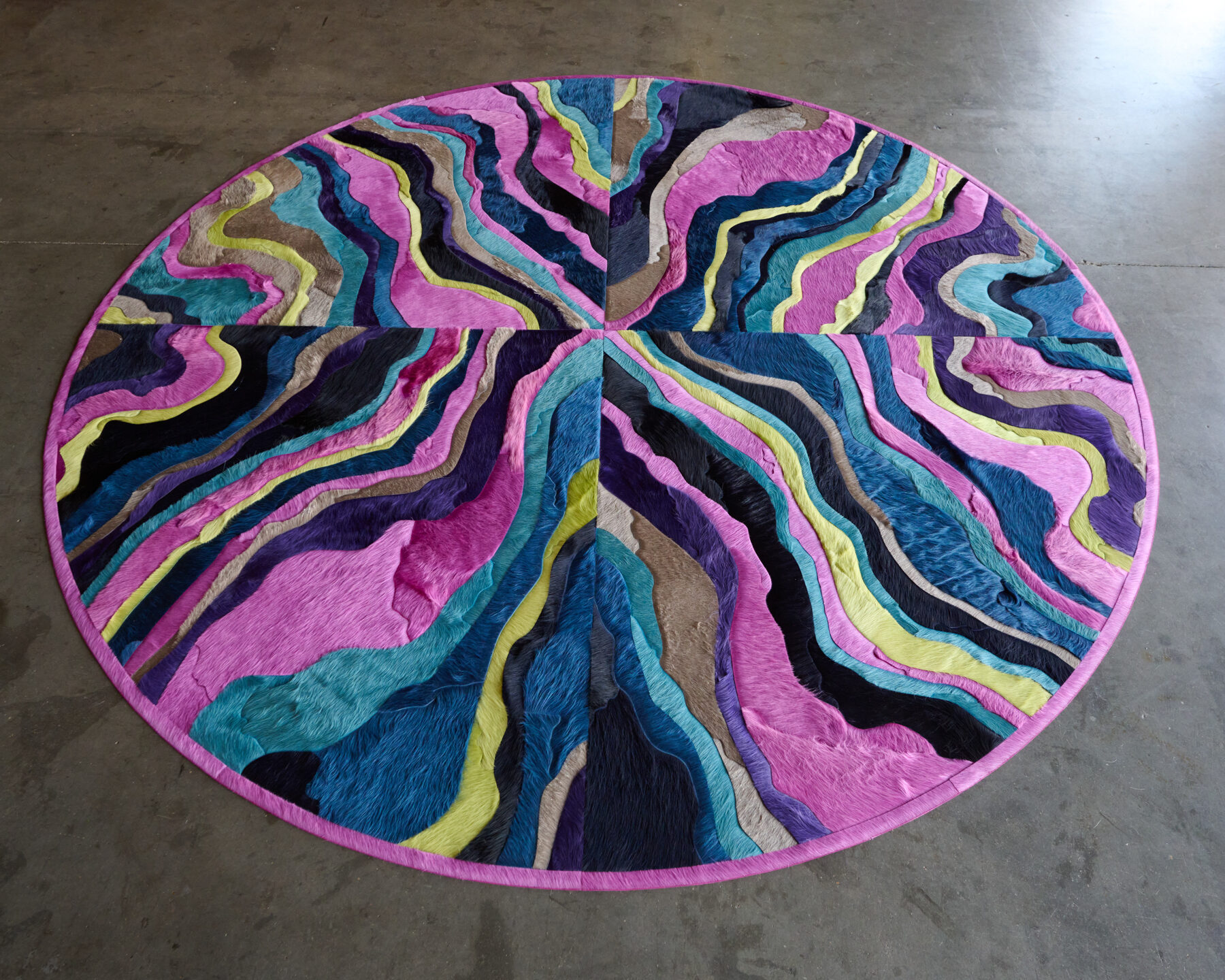Submerge 02842 is a luxury designer custom rug with wavy abstract bands on a concrete floor.