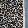 Luxury designer Custom 02927 rectangular rug with leopard print in high-end wool on a concrete floor.