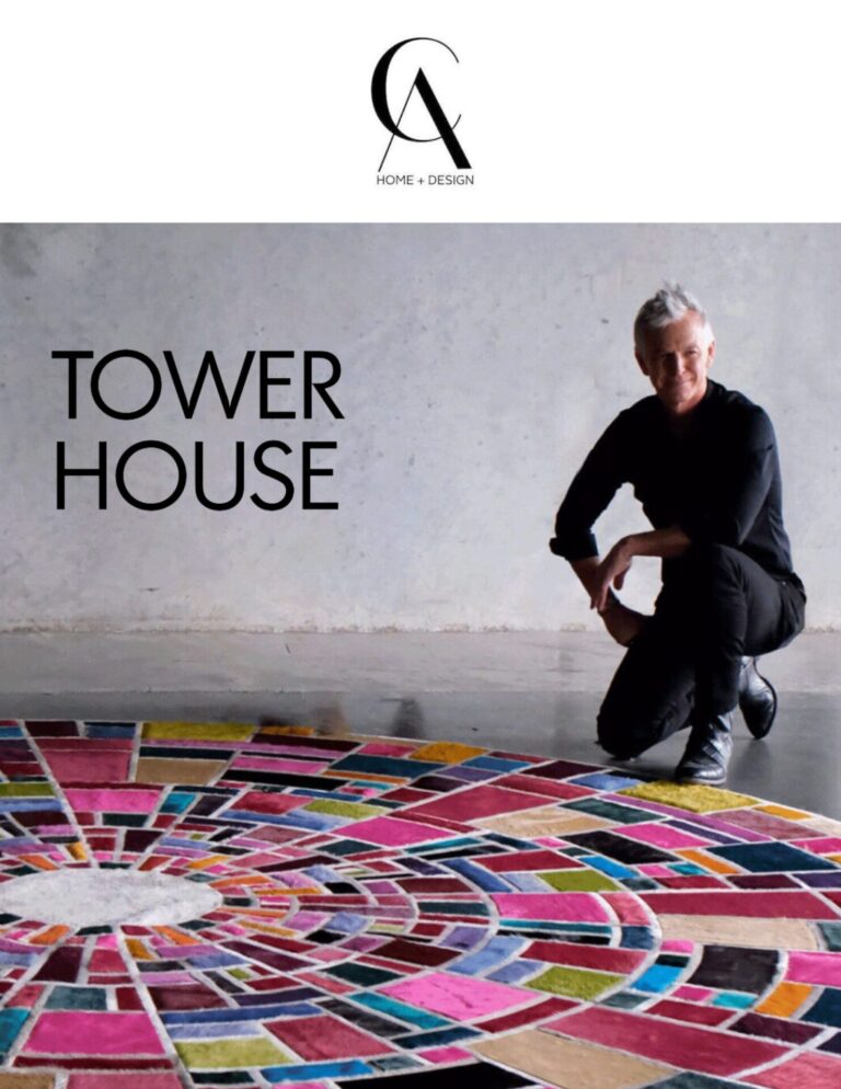 A person in black poses by a luxury custom circular designer rug, with "TOWER HOUSE" above.