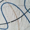 Silhouette Wool handmade designer rug with textured lines in blue, beige, and gray.
