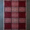 Luxury custom rug with a modern plaid design in red, pink, and black squares.
