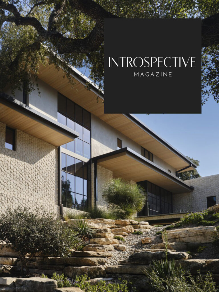 Modern California home with stone, glass, grand tree, and luxury custom rugs in view; "Introspective Magazine" logo (August 2025).