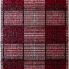A luxury designer rug featuring a plaid mosaic of red, pink, and black squares.
