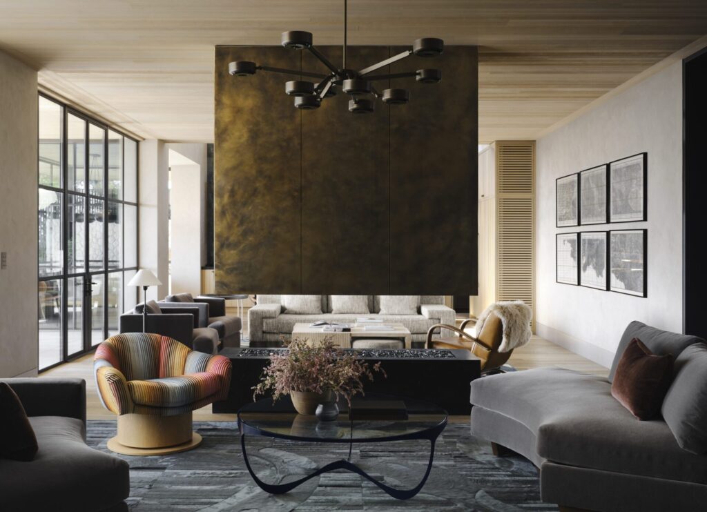 A modern living room with luxury custom designer rugs, metallic partition, and sunlight.