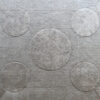 The Atlas 03145 luxury designer rug showcases intersecting circles on textured gray, crafted for high-end interiors.