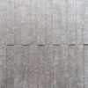 Close-up of Custom 03939 luxury designer rug showing textured surface and vertical grooves.