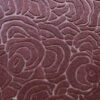 Close-up of Bloom 03996 luxury designer rug featuring a raised abstract swirl in reddish-brown wool.