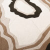 Luxury designer area rug with layered abstract shapes in beige and brown tones, perfect for high end modern interiors.
