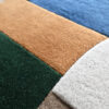 Close-up of textured luxury designer rug Forms 03618 with geometric shapes in premium wool.