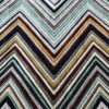 Luxury custom rug with chevron stripes in black, white, gray, red, yellow, and green.