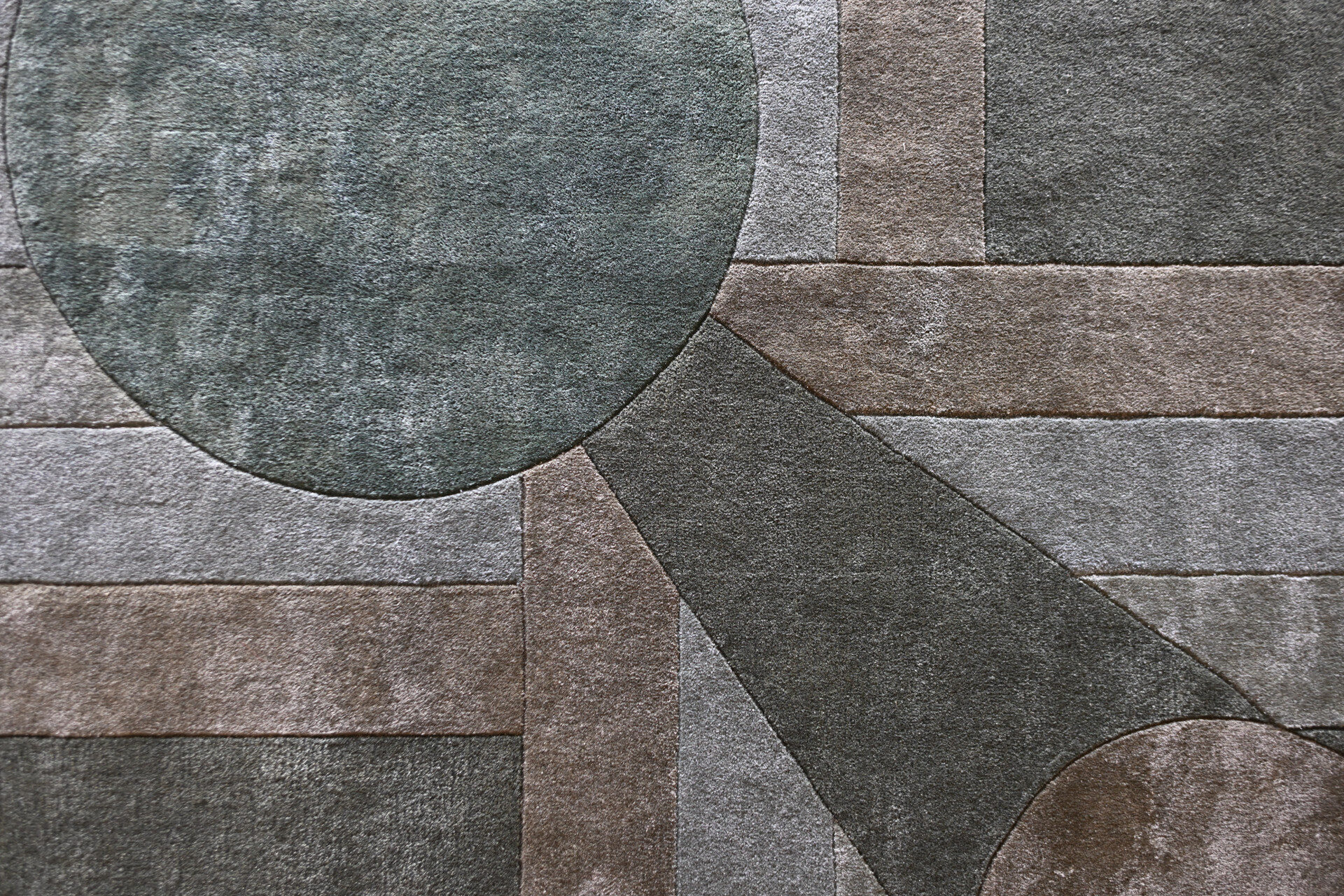 Atlas 03143 designer rug features geometric shapes in muted tones, evoking a luxury custom high end wool and silk carpet.
