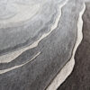 Close-up of high end designer rug 03476, showing layered rock-like texture in luxe grays and browns.