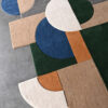 The Forms 03618 designer rug showcases luxe geometric shapes on a polished concrete floor.