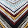 Close-up of luxury custom designer rug 03524 featuring textured chevron pattern in gray, gold, black, red, and light blue hues.