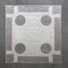 Luxury designer rug Atlas 03141 with geometric lines and circles in high-end wool on a gray floor.