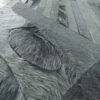 Close-up of luxury custom designer rug, highlighting layered textures and gray fur accents.