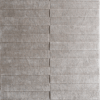 A luxury designer rug with textured beige wool, ridged detail, and custom notched edges.