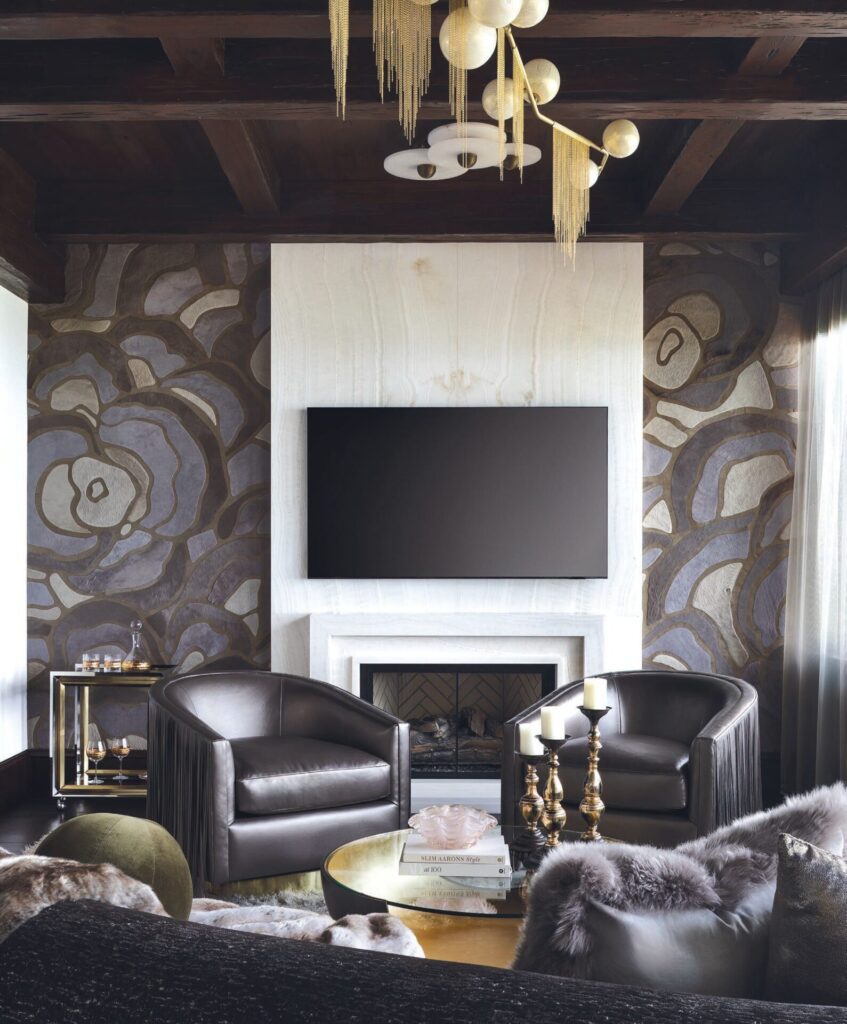 A modern living room with luxury designer rugs, dark armchairs, and gold accents.